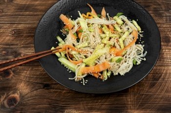 Salad with enoki mushrooms, carrots, cucumber, fried sesame seeds.. Chinese salad with enoki mushrooms.