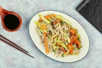 Salad with enoki mushrooms, carrots, cucumber, fried sesame seeds. Enokitake salad on a white plate. Flat lay.. Chinese salad with enoki mushrooms.