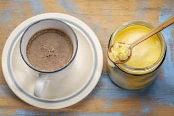 cup of fresh fatty coffee with ghee (clarified butter) - ketogenic diet concept