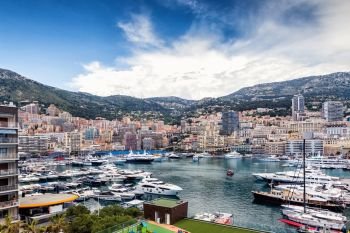 Principality of Monaco. Beautiful panoramic view on Monaco, golden hour scenery. View on apartment building, casino, great port with luxury yachts. Monaco is popular travel destination, wealth symbol. - Image