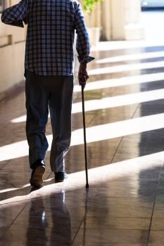 an old man with a cane on the sidewalk