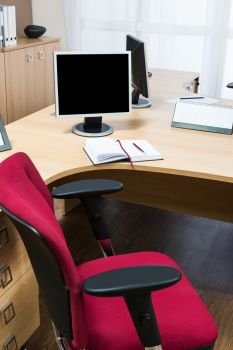 monitors on a desk in a modern office