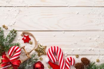 Christmas composition with decorations on wooden background. Copy space. Top view 