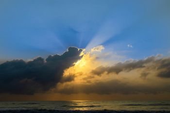 Nature view of sunrise beams over the tropical sea beach
