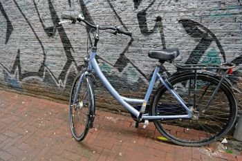 Old dutch bike against a graffiti wall in Amsterdam Netherlands