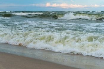 sea wave rolls on the sand, sandy coast of the Baltic sea. sea wave rolls on the sand