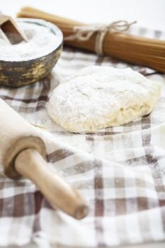 dough for pasta. dough for pasta on wooden table with flour