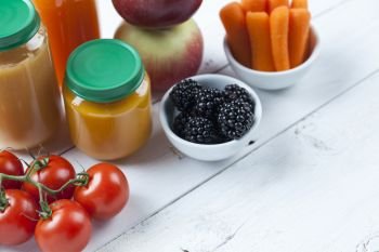 healthy ready-made baby food on a wooden table.