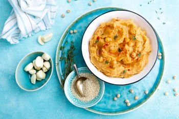 Hummus with chickpea and tahini, delicious and healthy protein vegan and vegetarian food, top view, flat lay
