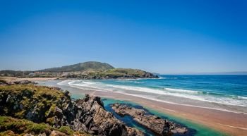 Landscape with sea,cliff, beach and blue sky. Galicia Spain. Vacation travel.