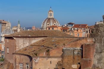 A view of the tiled roofs and an antique arch in the old town. Rome. Italy.. Rome. View of the old town.