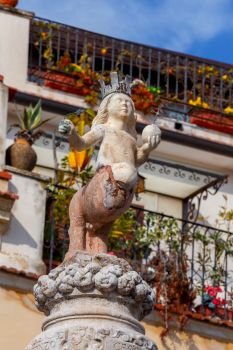The famous city fountain in Taormina on the square on a sunny day. Italy. Sicily.. Taormina. Sicily. City fountain.
