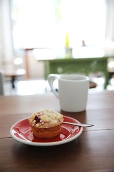 Blueberry muffin with hot tea on wood background
