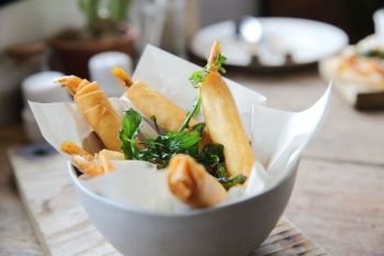 Spring rolls with shrimp with sweet chili sauce. Asian food on wood background
