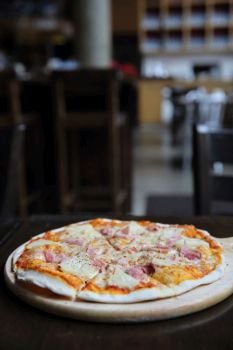 pizza hawaiian , pizza with pineapple and ham with cheese and tomatoes sauce on wood background , italian food