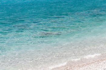 Clear turquoise water rocky beach of Porto Germeno, Attica, Greece