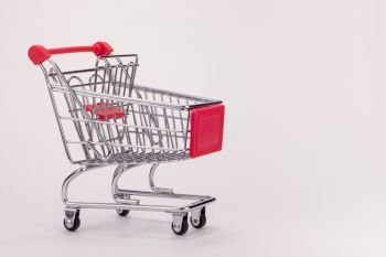 An empty grocery cart with expansion shelf on white background