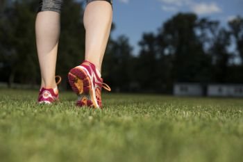 Close up of feet of a runner, training concept. Fitness woman running, Training and healthy lifestyle