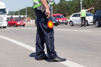 Police officer controlling traffic on the highway