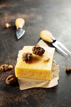 cheese with walnut, cheese on paper on a table