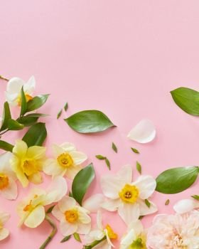 Wedding, Valentine’s Day, Women’s Day. Top view of white flowers with green leaves covering pink background. Blank copy space for noting emotions, ideas.. White flowers covering background