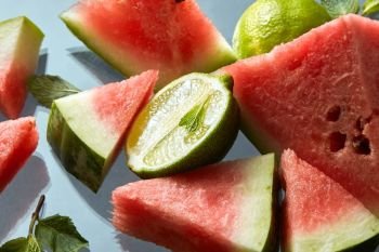 watermelon and lime slices on a plate. watermelon and lime slices