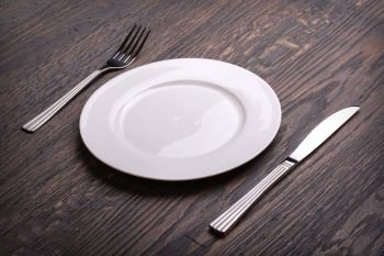 white plate on wooden table background