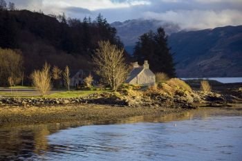 Evening sunlight on a country cottage on the banks of Loch Duich in the northwest of Scotland. UK.