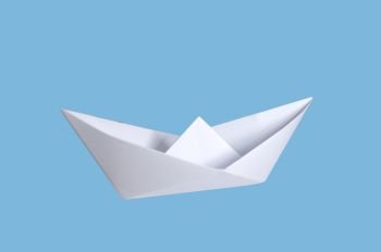 origami paper boat isolated on blue background 