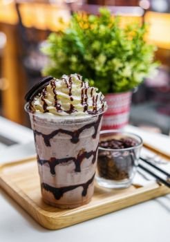 chocolate frappe with whipped cream on table