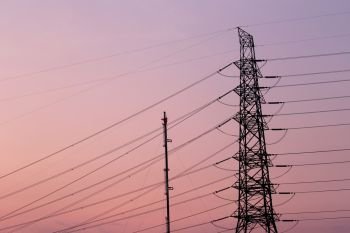 silhouette of high voltage electric tower in twilight sky