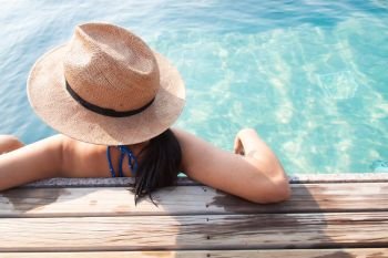 Asian woman relaxing in swimming pool, Travel vacation concept