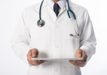 Young medical doctor holding a tablet pc isolated on grey.