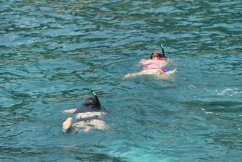 Phuket, THAILAND - JANUARY 4, 2017. A tourist wearing a bikini swim in the sea in Phuket.