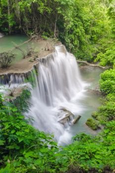 Erawan Waterfall, beautiful waterfall with sunlight rays in deep forest, Erawan National Park in Kanchanaburi, Thailand