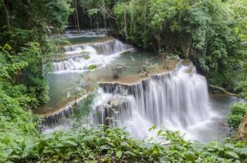 Erawan Waterfall, beautiful waterfall with sunlight rays in deep forest, Erawan National Park in Kanchanaburi, Thailand
