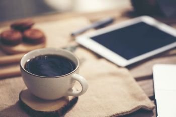 Laptop computer, phone and coffee in the garden - freelance or remote work concept