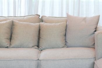 Gray pillows setting on gray sofa in living room