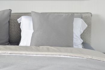 Gray and white pillows on bed in gray color scheme