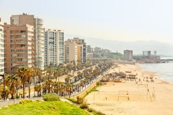 Seaside promenade with modern building, road, sandy beach and sea, Beirut, Lebanon