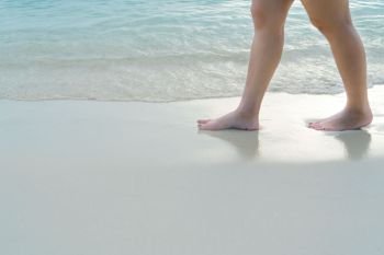 Beach travel - blur girl’s walking on the white sand beach, vacation and relax - soft skin filter