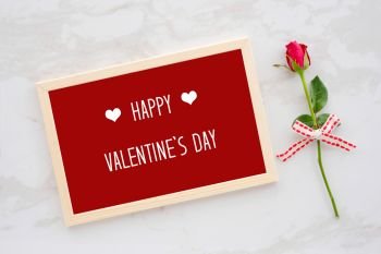 Happy valentine’s day card in wooden frame and red rose on white marble  background, banner, flat lay 