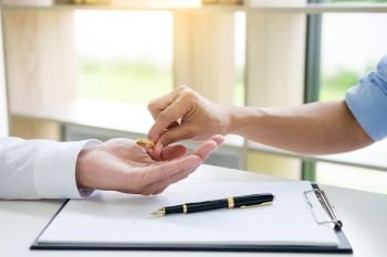 Hands of wife, husband signing decree of divorce, dissolution, canceling marriage, lfiling divorce papers or premarital agreement prepared by lawyer. Wedding ring