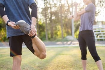 Early morning workout, Fitness couple stretching outdoors in park. Young man and woman exercising together in morning, Relationship healthy lifestyle fitness, sport concept