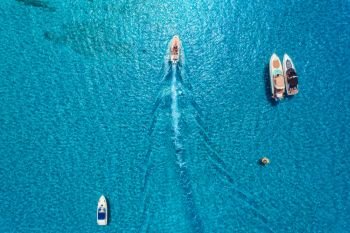 Yachts at the sea in Balearic islands, Spain. Aerial view of luxury floating boat in transparent blue water at sunny day. Summer landscape. Top view from drone. Seascape with motorboat in bay. Travel
