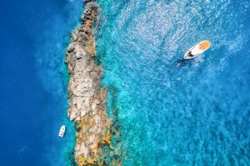 Aerial view of beautiful yacht on the sea at sunset in summer. Akvaryum koyu in Turkey. Top view of luxury yacht, motorboat, stones, rock, beach, mountain. Travel. Boat and clear blue water. Nature 