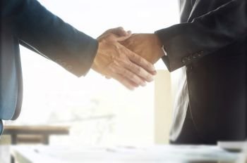 business ceo hands shaking while meeting selected focus on hands