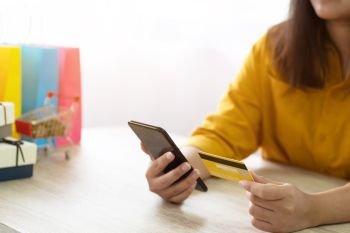 woman using credit card shopping online with mobile smartphone