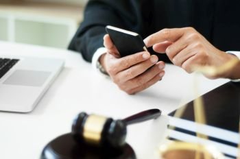 man searching law charter with smartphone in law firm.