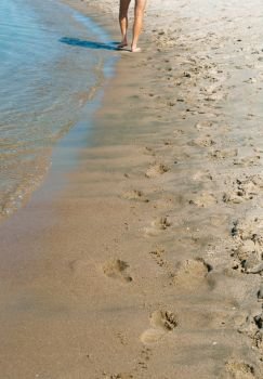 human footprints in the sand, walking barefoot on the beach. walking barefoot on the beach, human footprints in the sand